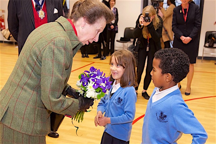 HRH is presented with a posy by two pupils of The Dolphin School.